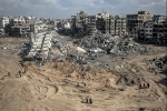 People wander through the devastated area in Gaza